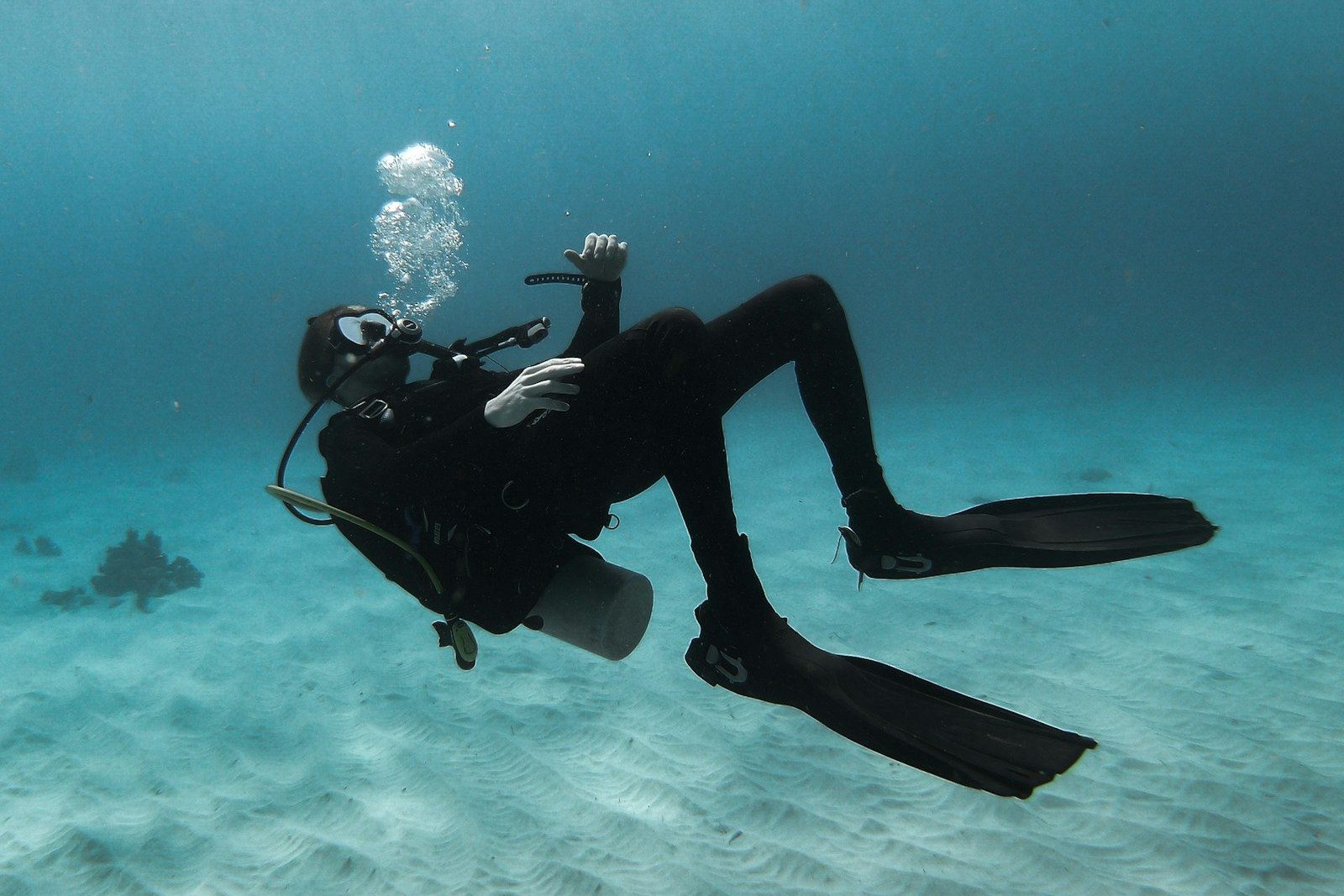 man in scuba diving suit in water